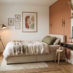 Cool room ideas: small bedroom with terracotta accent wall, storage bed, floating desk, wall sconces and gallery wall