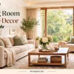 Living room table decor with a wooden coffee table, decorative books, flowers, candles, and a tray in a warm neutral living room